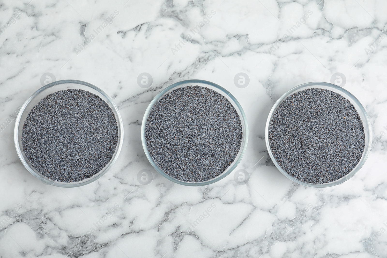 Photo of Flat lay composition with poppy seeds on marble background