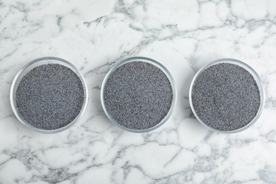 Flat lay composition with poppy seeds on marble background