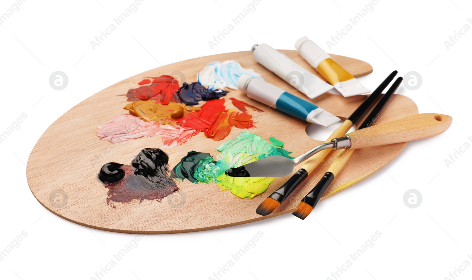 Photo of Wooden palette with oil paints and tools on white background