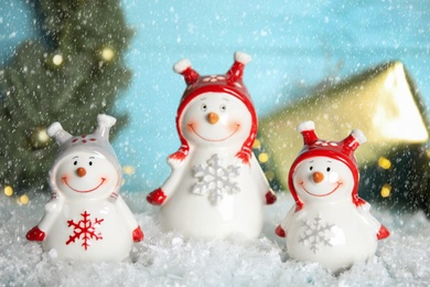 Photo of Funny little snowmen on table. Christmas decor