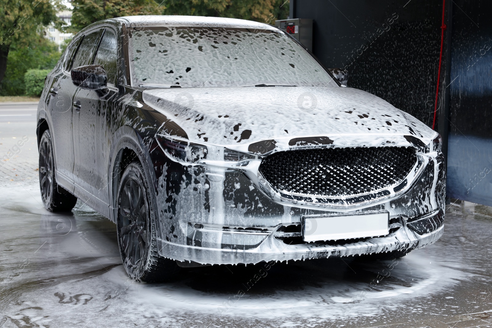 Photo of Auto with cleaning foam at car wash
