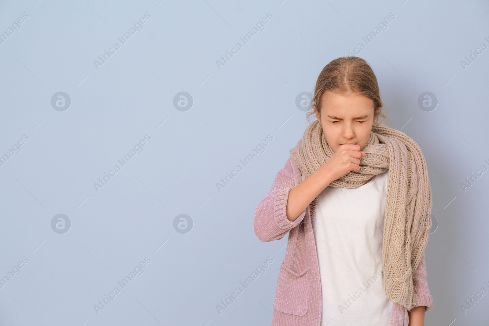 Photo of Girl coughing on light background