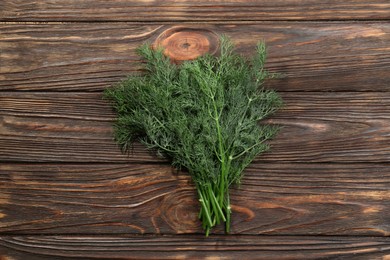 Bunch of fresh green dill on wooden table, top view