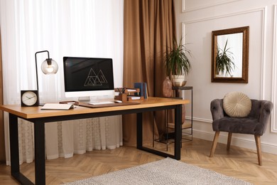 Photo of Stylish room interior with comfortable workplace near window