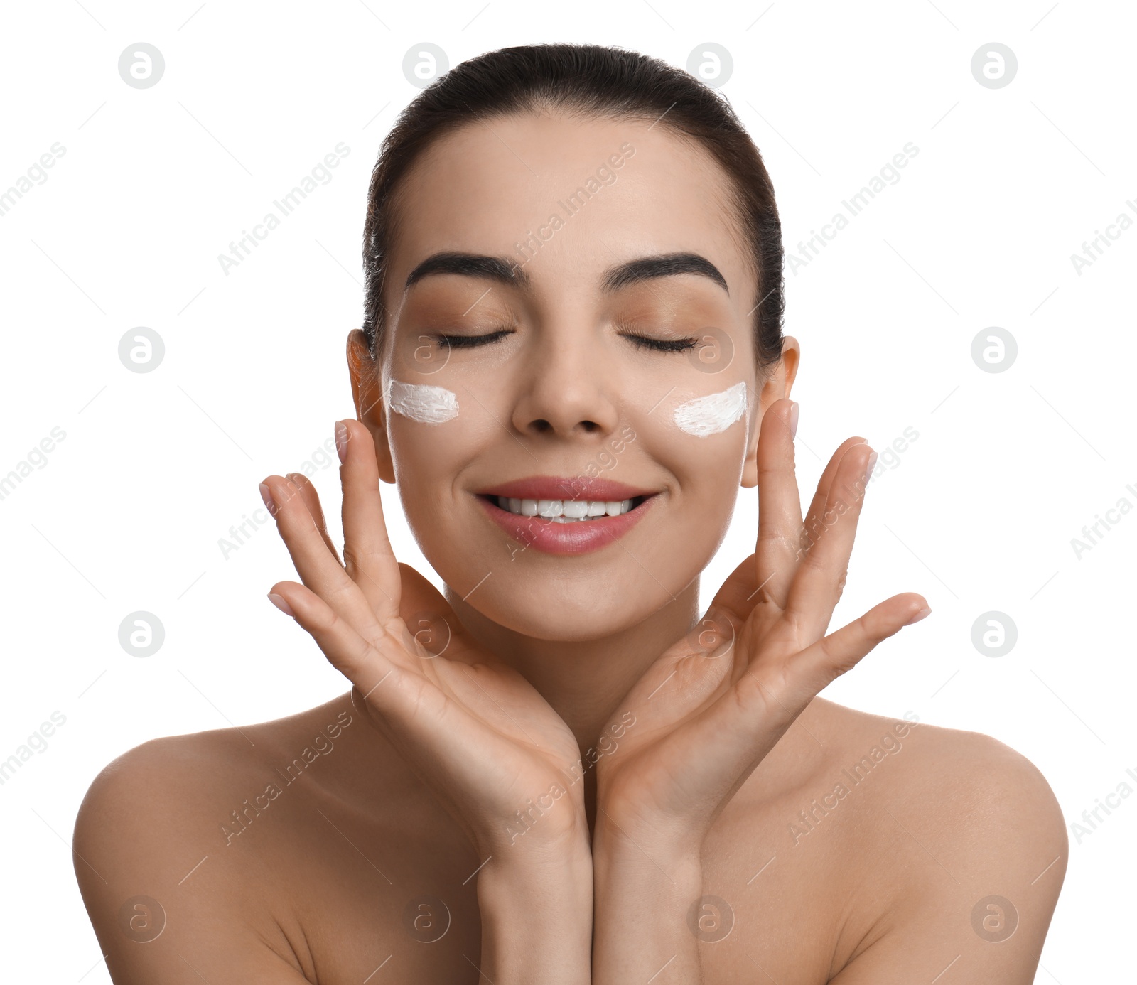 Photo of Young woman applying facial cream on white background