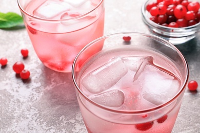 Refreshing natural lemonade in glasses on table