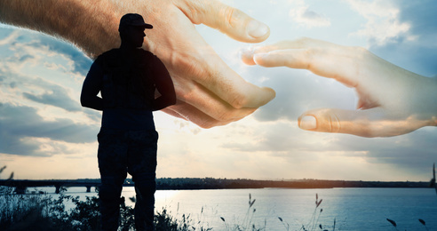 Image of Double exposure of helping hand and soldier in uniform outdoors