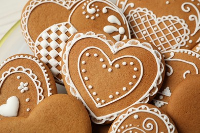 Photo of Tasty heart shaped gingerbread cookies, closeup view