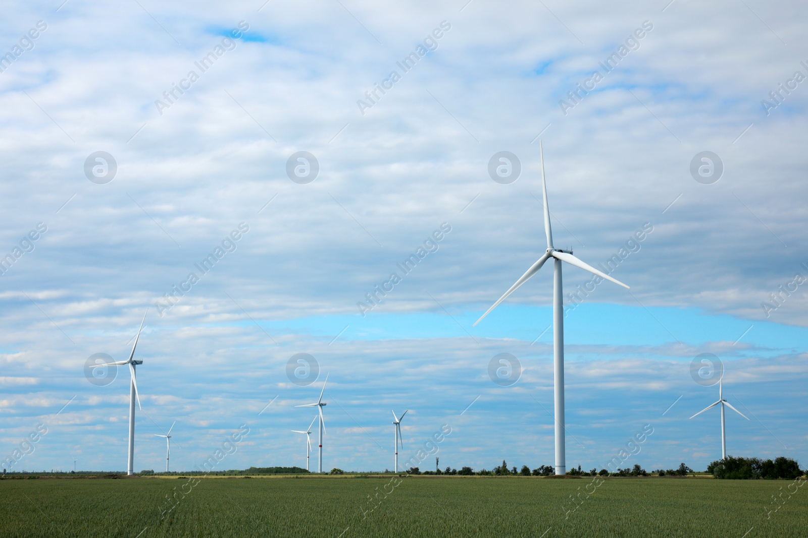 Photo of Beautiful view of field with wind turbines. Alternative energy source