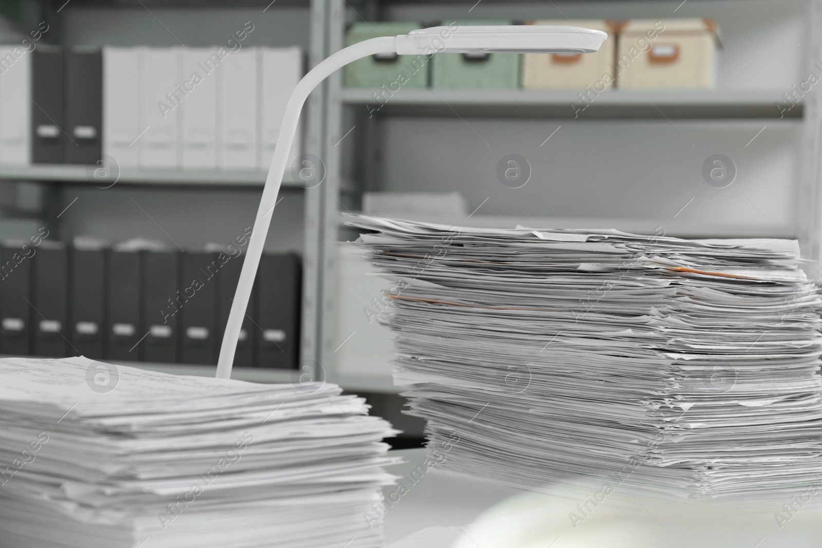 Photo of Stacks of documents on table in office