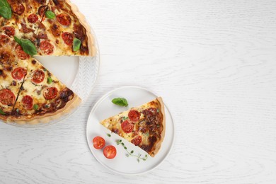 Photo of Cut delicious homemade quiche with prosciutto, tomatoes and basil on white wooden table, flat lay. Space for text