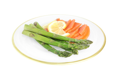 Photo of Tasty asparagus with salmon and lemon isolated on white