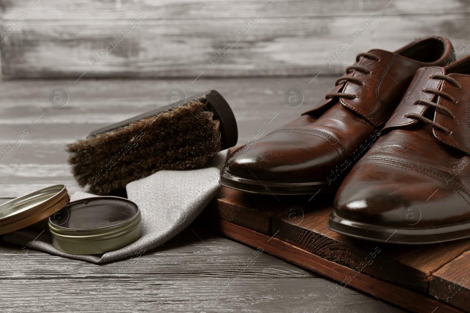 Photo of Footwear and shoe shine kit on grey table