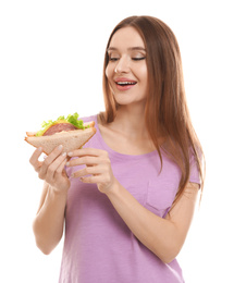 Young woman with tasty sandwich on white background