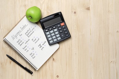 Photo of Notebook with products of low, moderate and high glycemic index, pen, calculator and apple on wooden table, flat lay. Space for text
