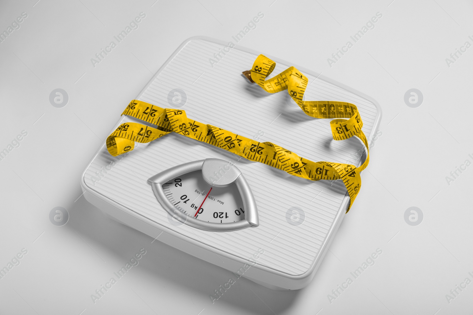 Photo of Weight loss concept. Scales and measuring tape on white background