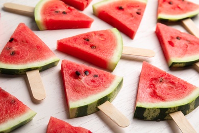 Slices of ripe watermelon on white wooden table