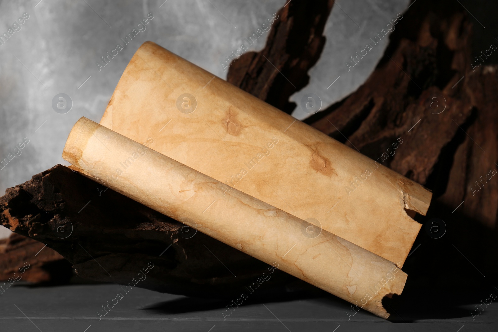 Photo of Sheet of old parchment paper on grey wooden table