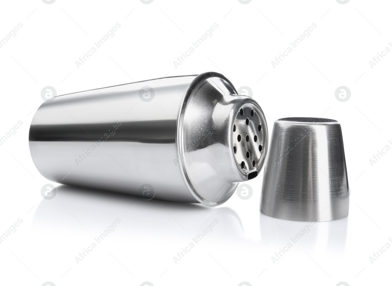 Photo of Metal cocktail shaker and cup isolated on white