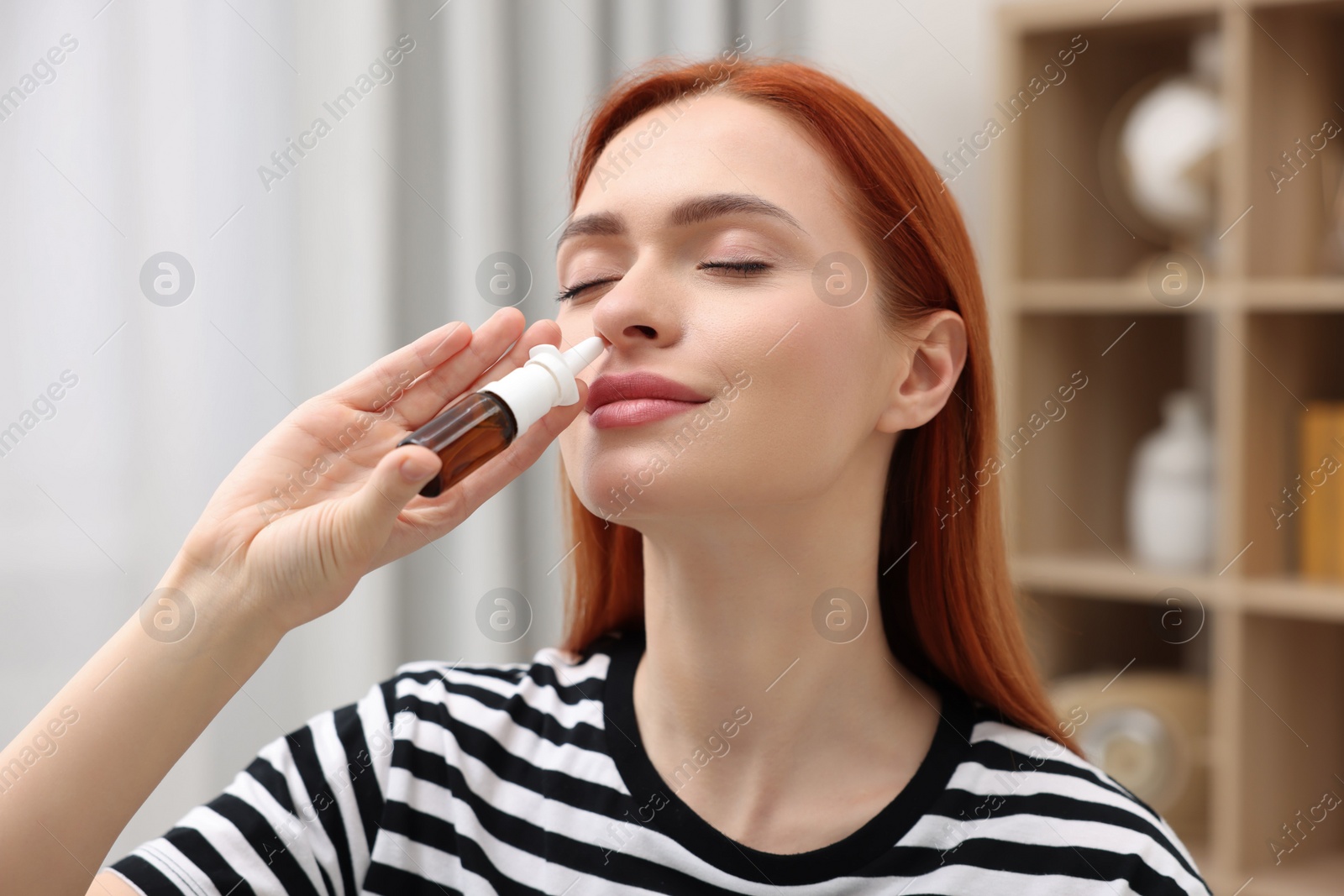 Photo of Medical drops. Woman using nasal spray at home