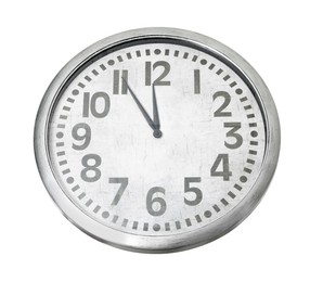 Photo of Clock showing five minutes until midnight on white background. New Year countdown