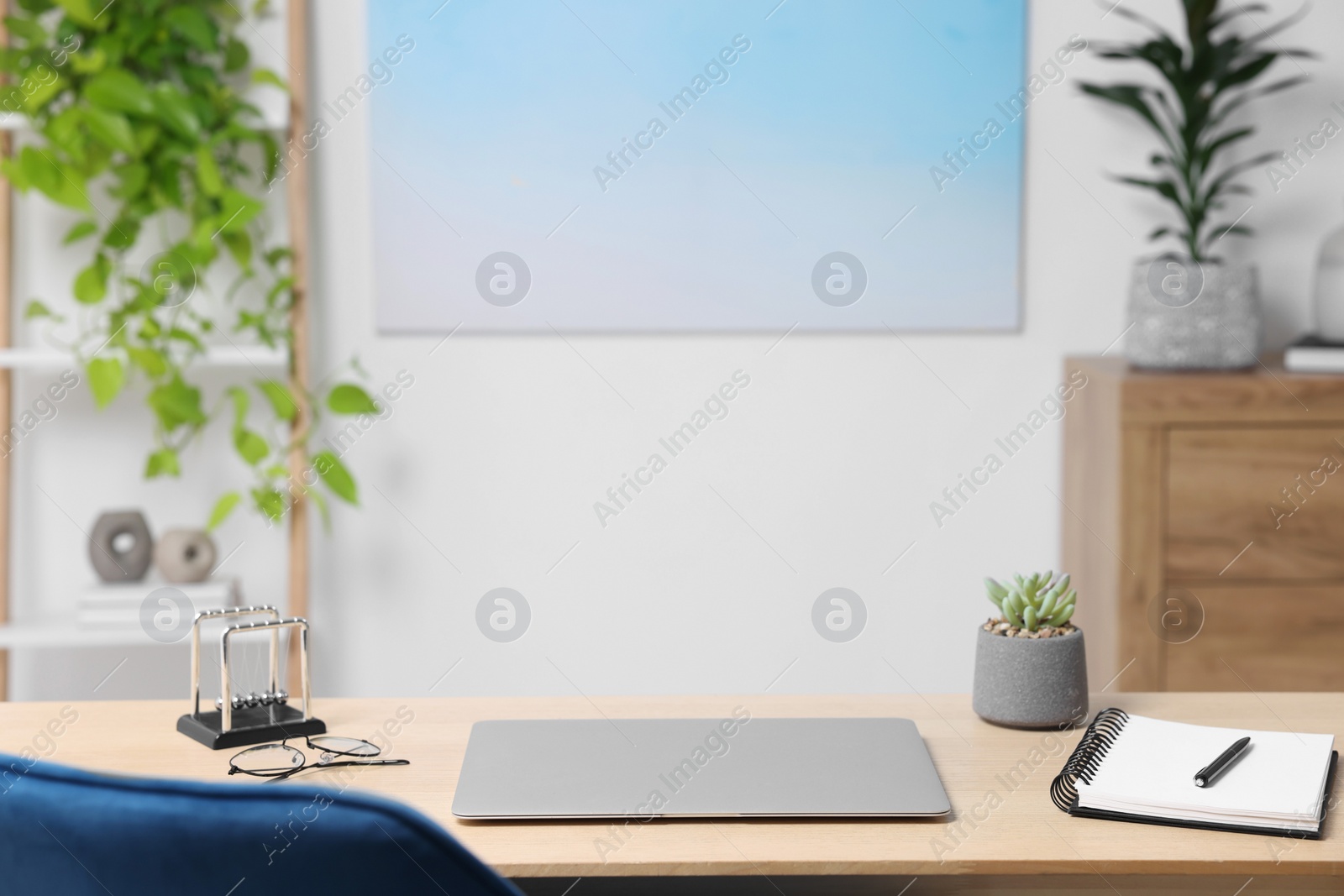 Photo of Home workspace. Laptop and stationery on wooden desk indoors