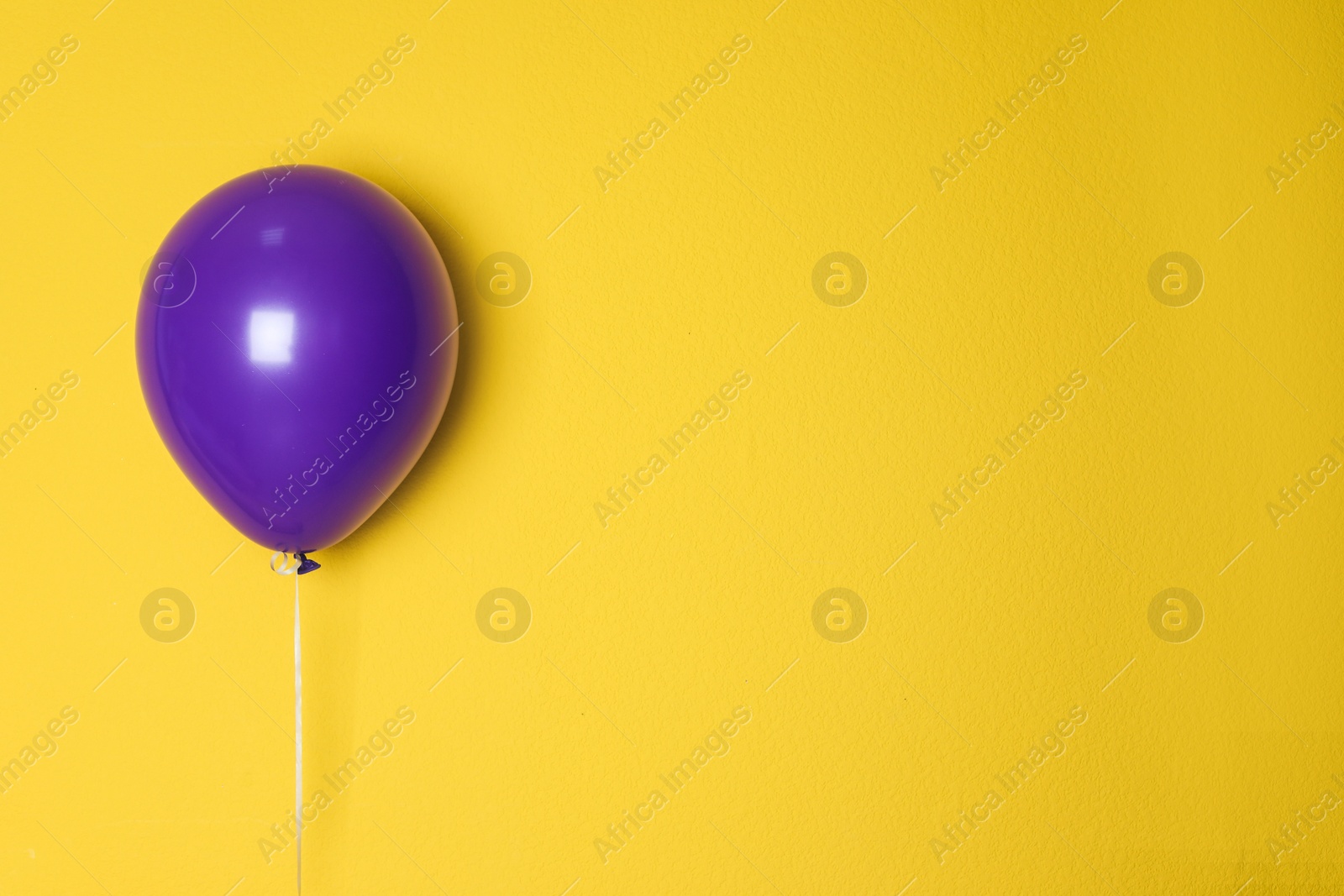 Photo of Purple balloon on color background. Celebration time