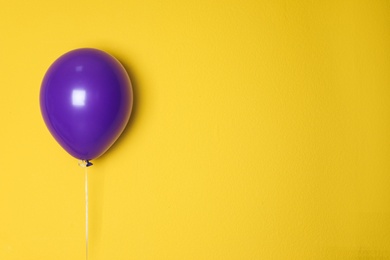 Photo of Purple balloon on color background. Celebration time