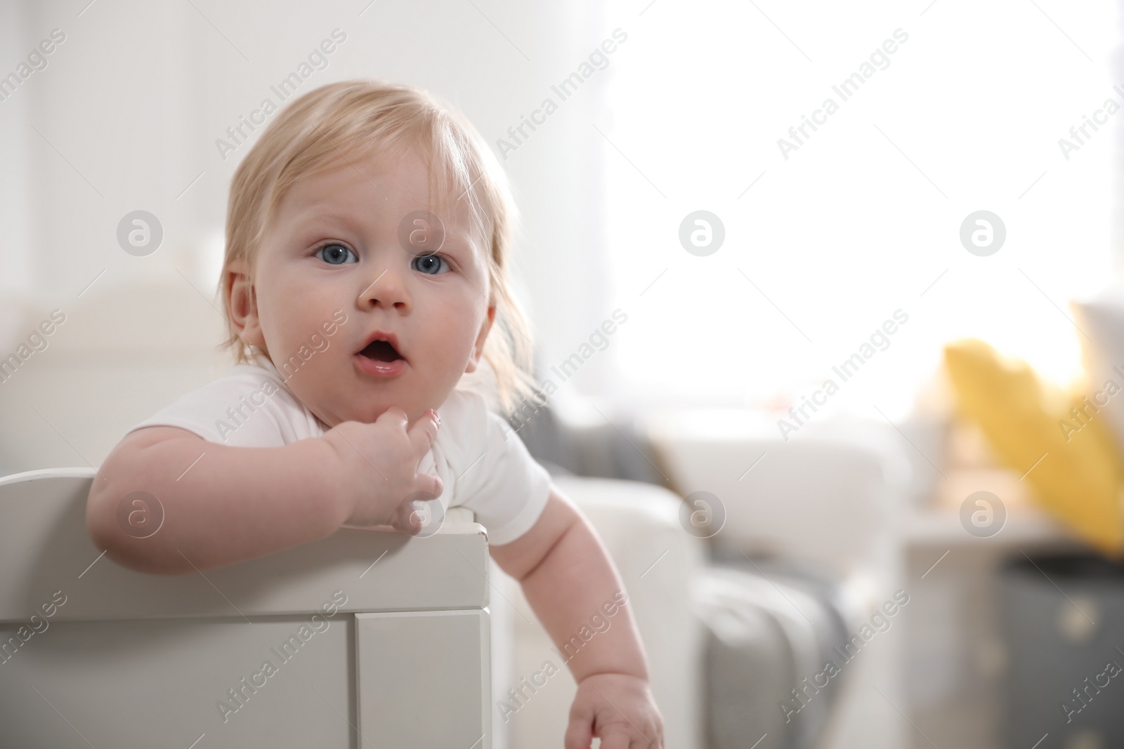 Photo of Adorable little baby in crib at home