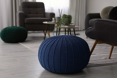 Stylish comfortable poufs and armchairs in room. Home design