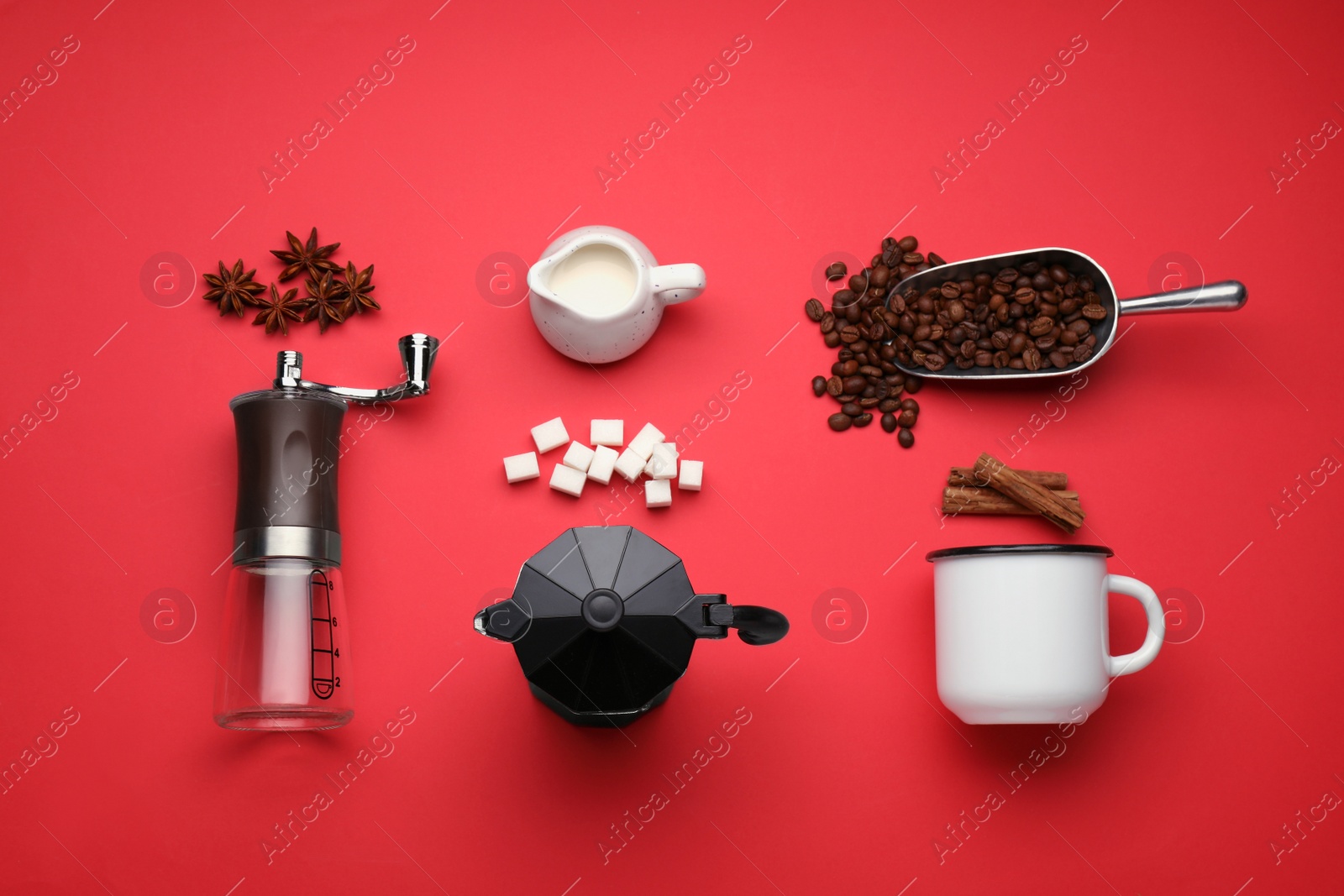 Photo of Flat lay composition with manual coffee grinder and spices on red background