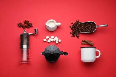 Photo of Flat lay composition with manual coffee grinder and spices on red background