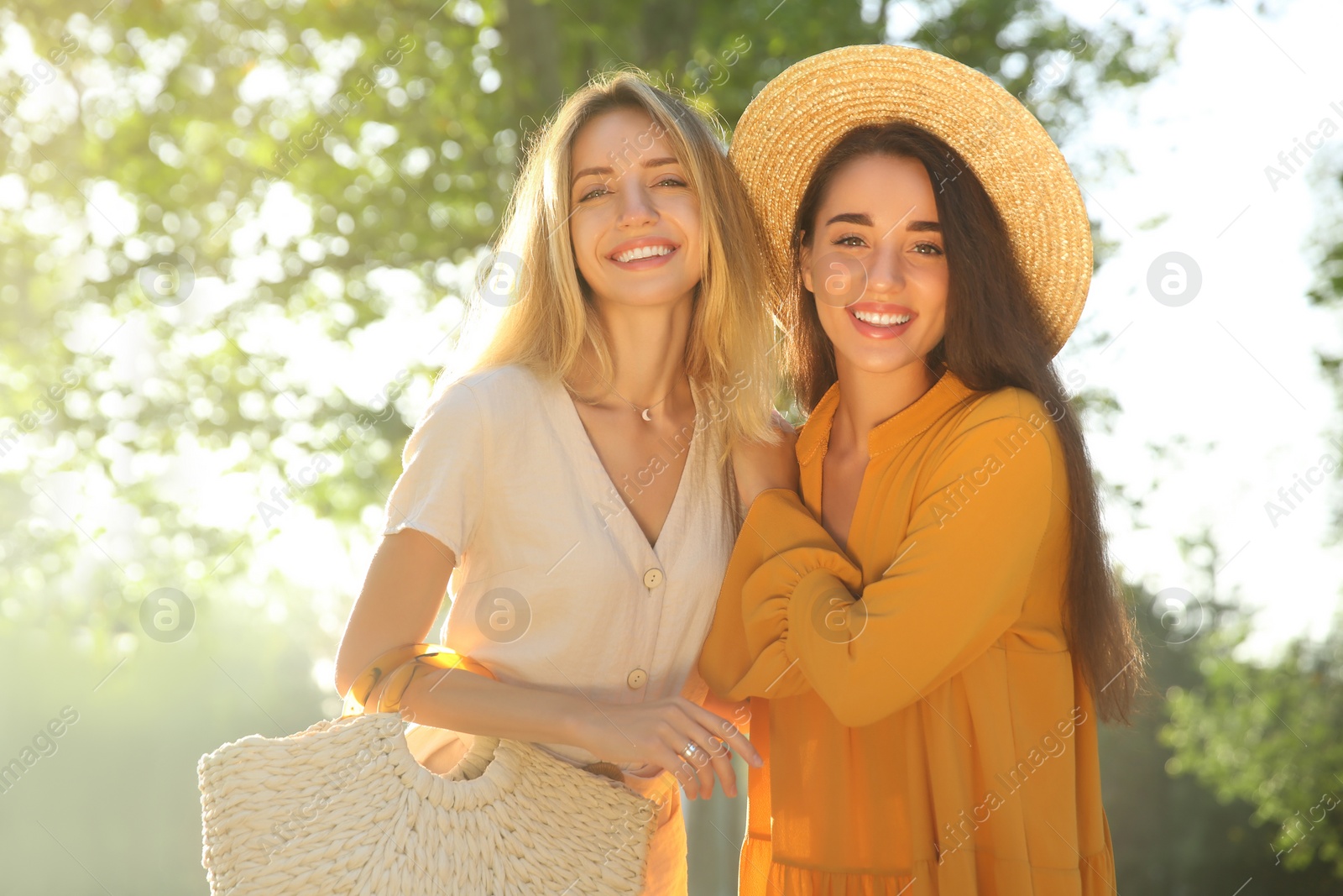 Photo of Beautiful young women in stylish dresses outdoors