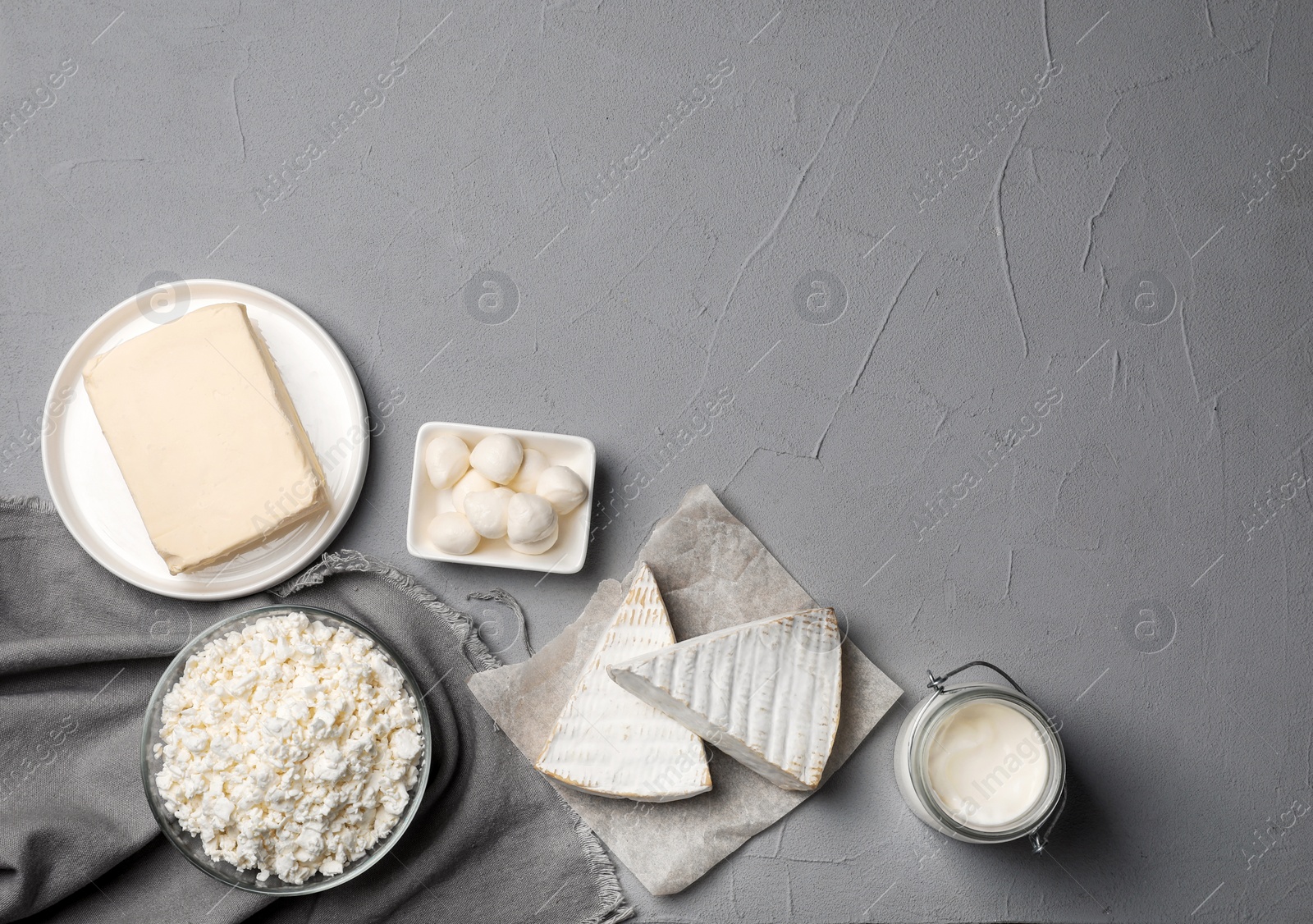 Photo of Fresh dairy products on gray background, top view