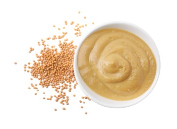 Photo of Fresh tasty mustard sauce in bowl and dry seeds isolated on white, top view