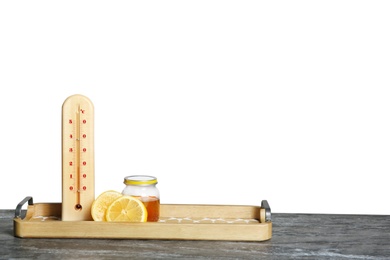 Photo of Thermometer, lemon and honey on table against gray background. Space for text