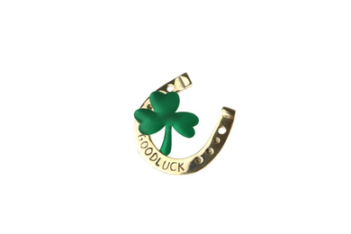 Photo of Golden horseshoe with phrase GOOD LUCK and clover on white background. St. Patrick's Day celebration