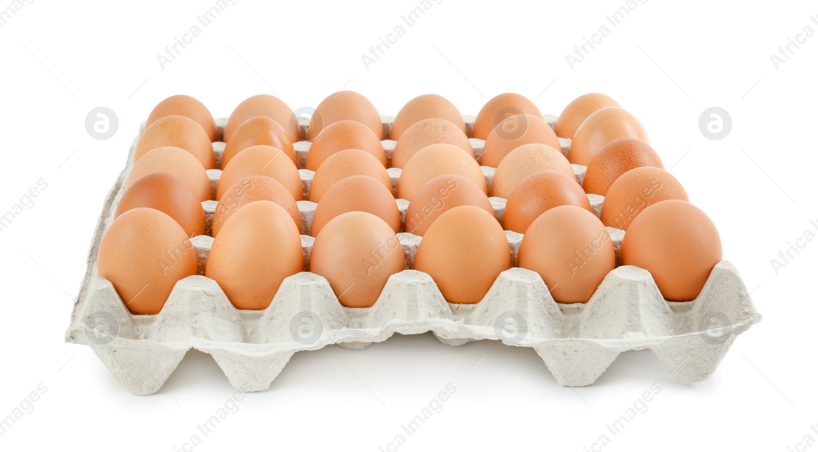 Photo of Raw chicken eggs in carton tray isolated on white