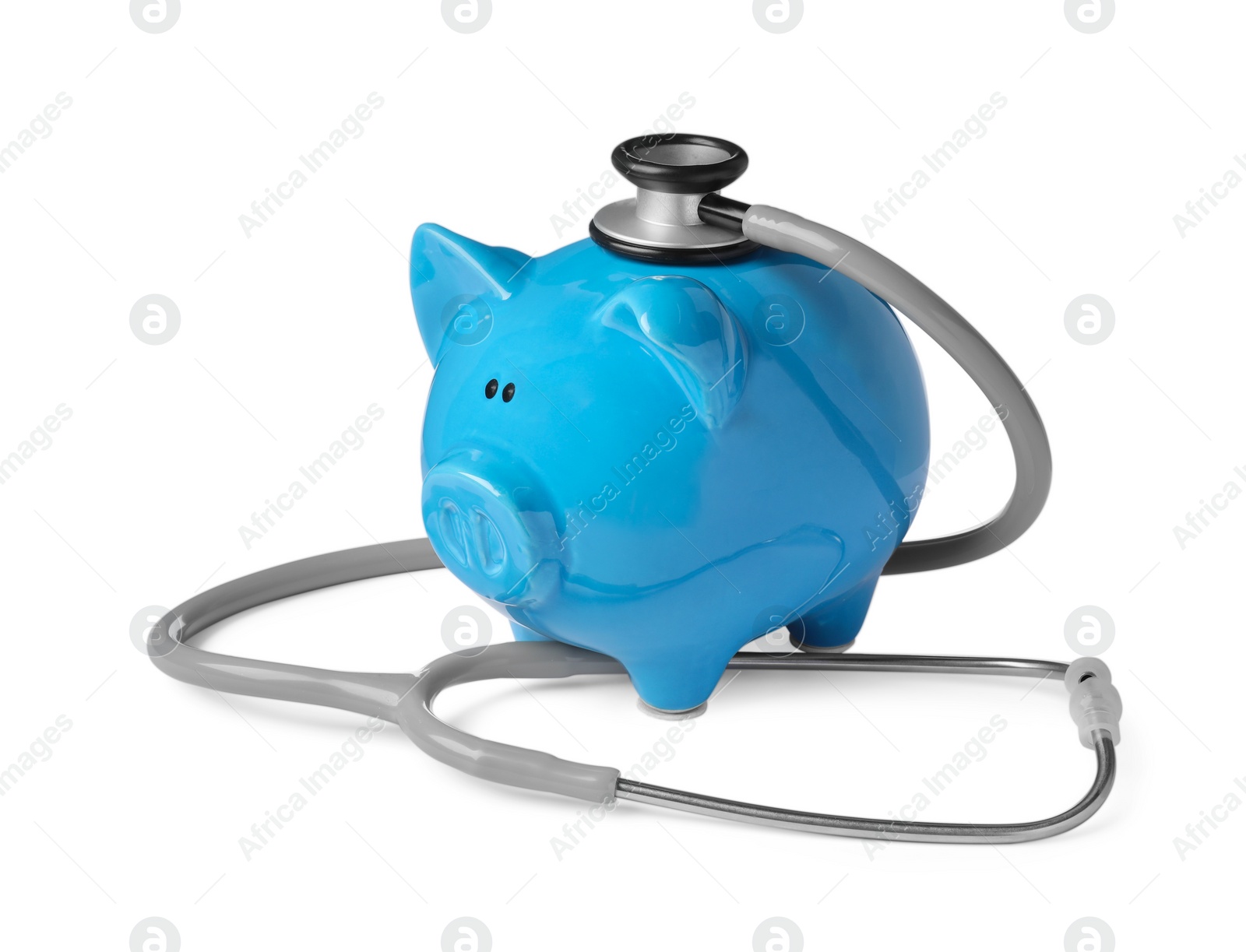 Photo of Piggy bank with stethoscope on white background. Medical insurance