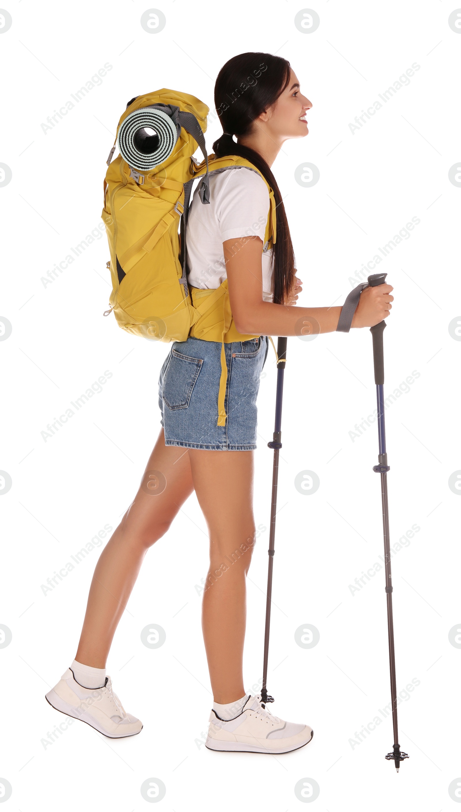 Photo of Female hiker with backpack and trekking poles on white background