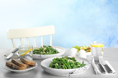 Photo of Tasty green beans with almonds served for dinner on table