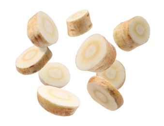 Image of Pieces of parsnip root falling on white background