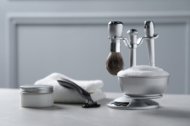 Photo of Set of men's shaving tools on grey table. Space for text