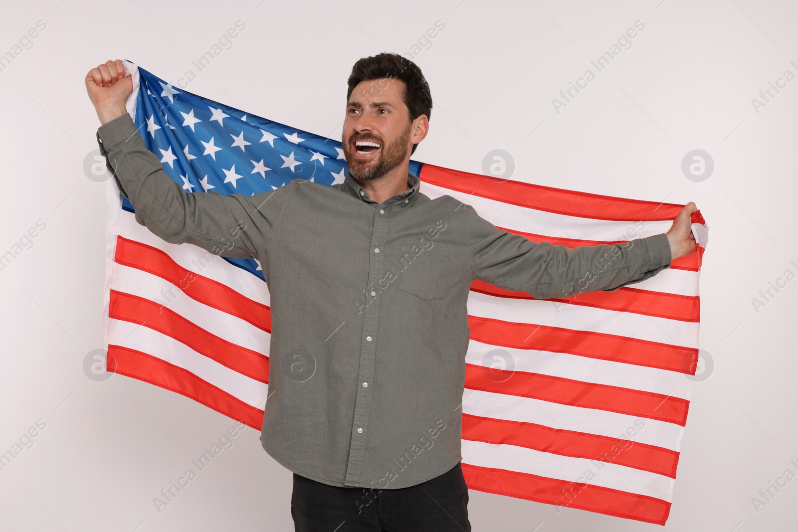 Photo of 4th of July - Independence Day of USA. Happy man with American flag on white background