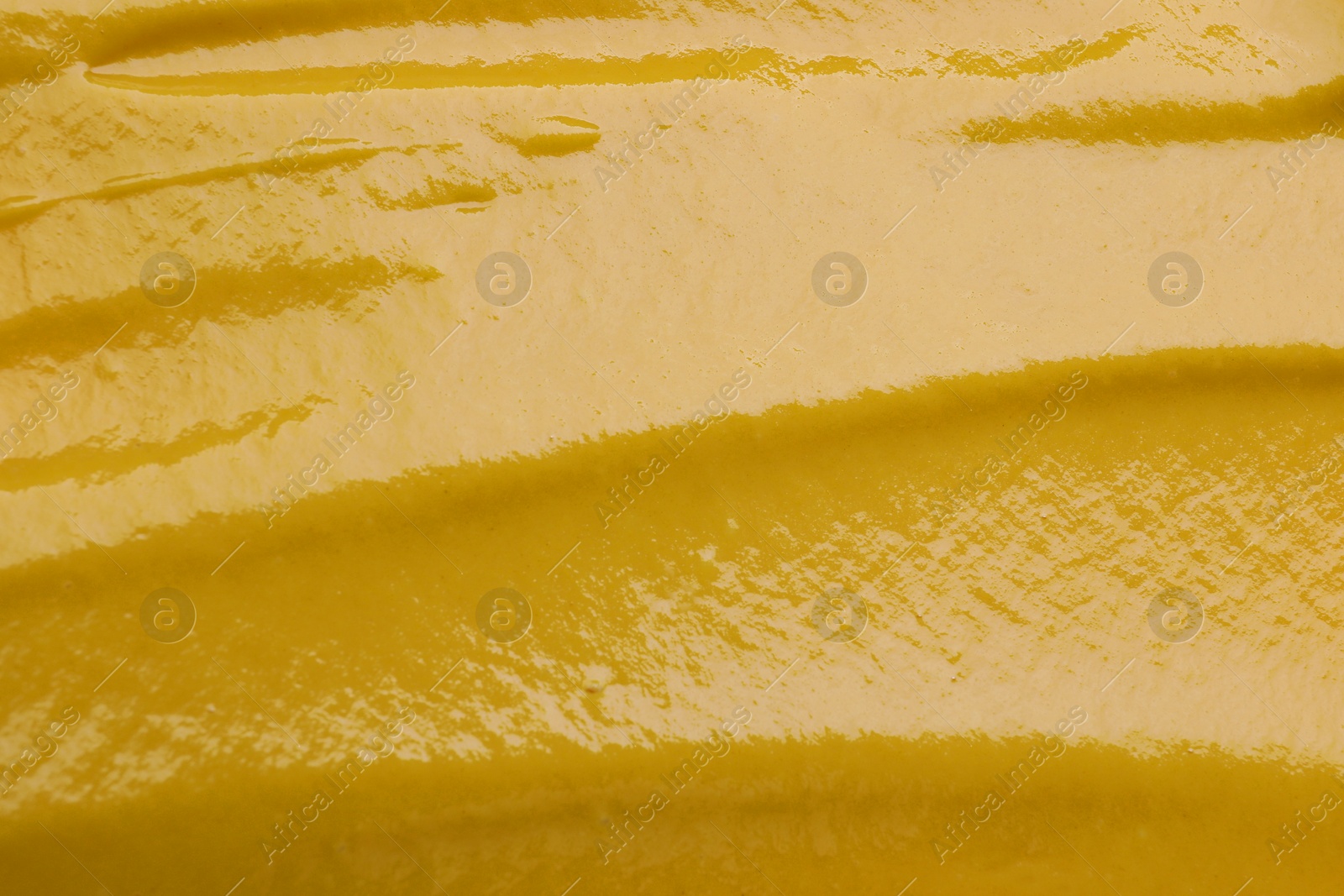 Photo of Texture of delicious mustard as background, top view