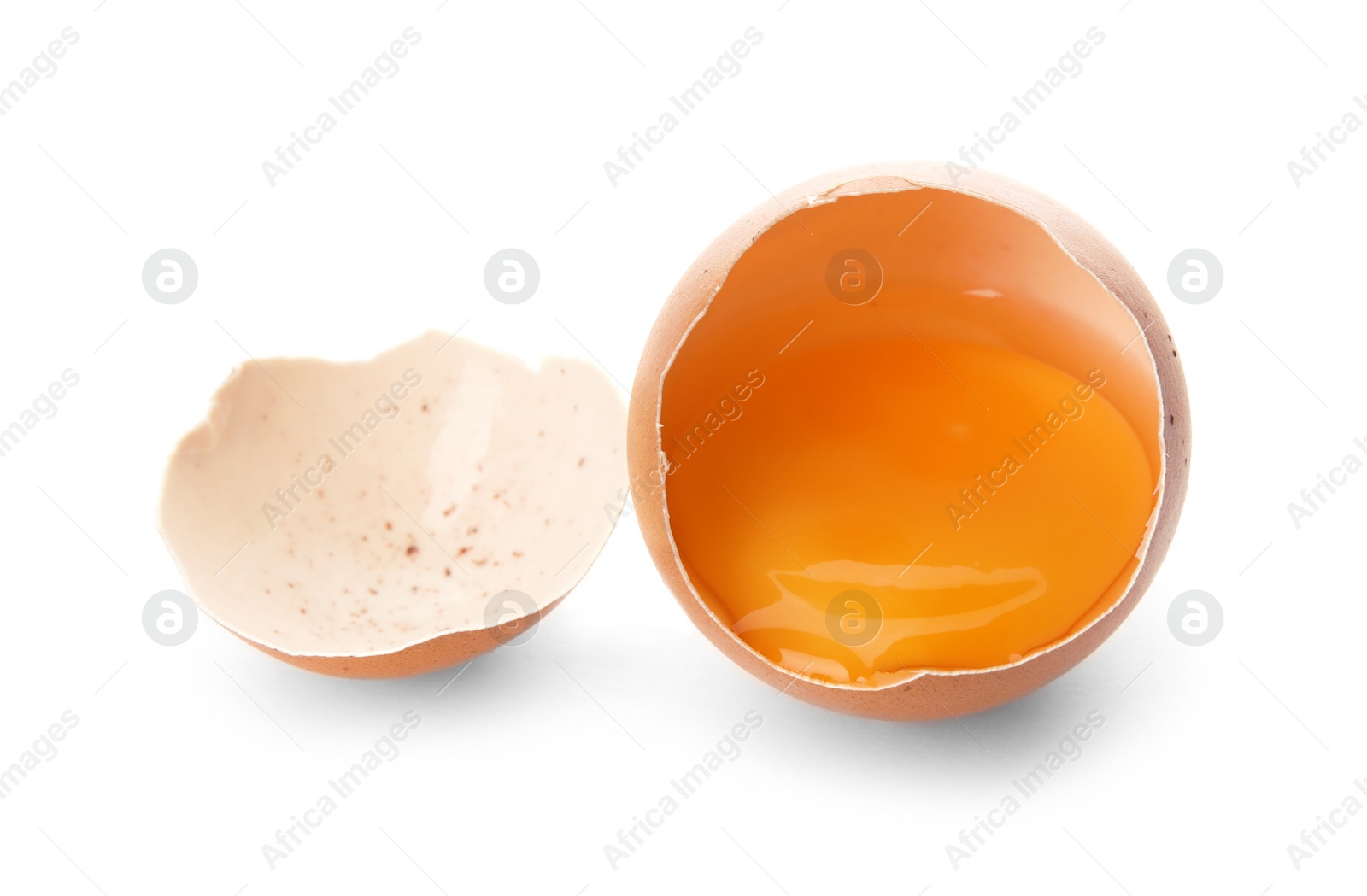 Photo of Cracked raw chicken egg with yolk on white background