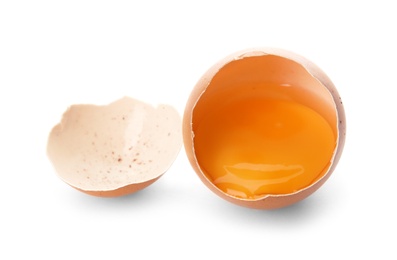 Photo of Cracked raw chicken egg with yolk on white background