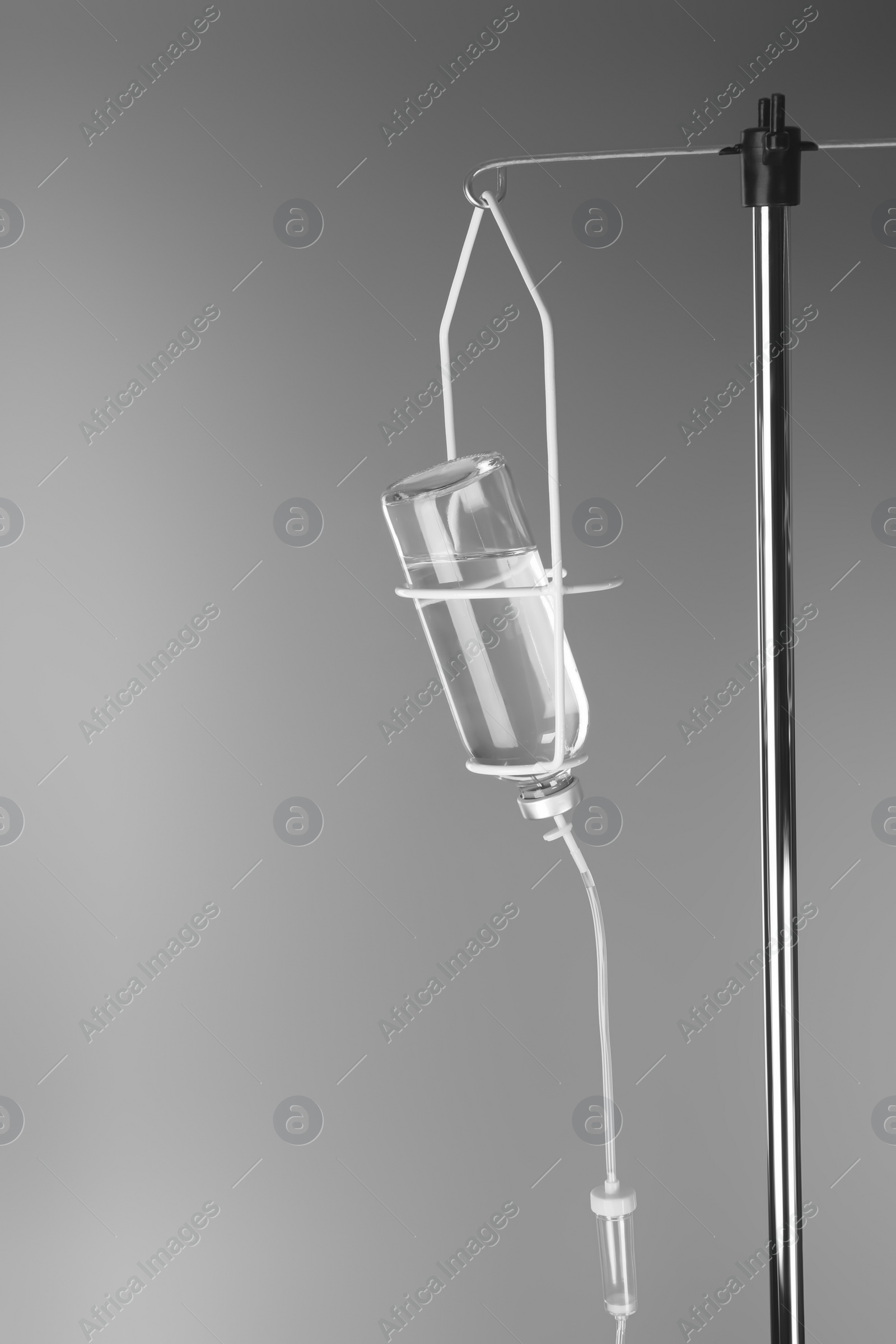 Photo of Drop counter with bottle of medicine on grey background