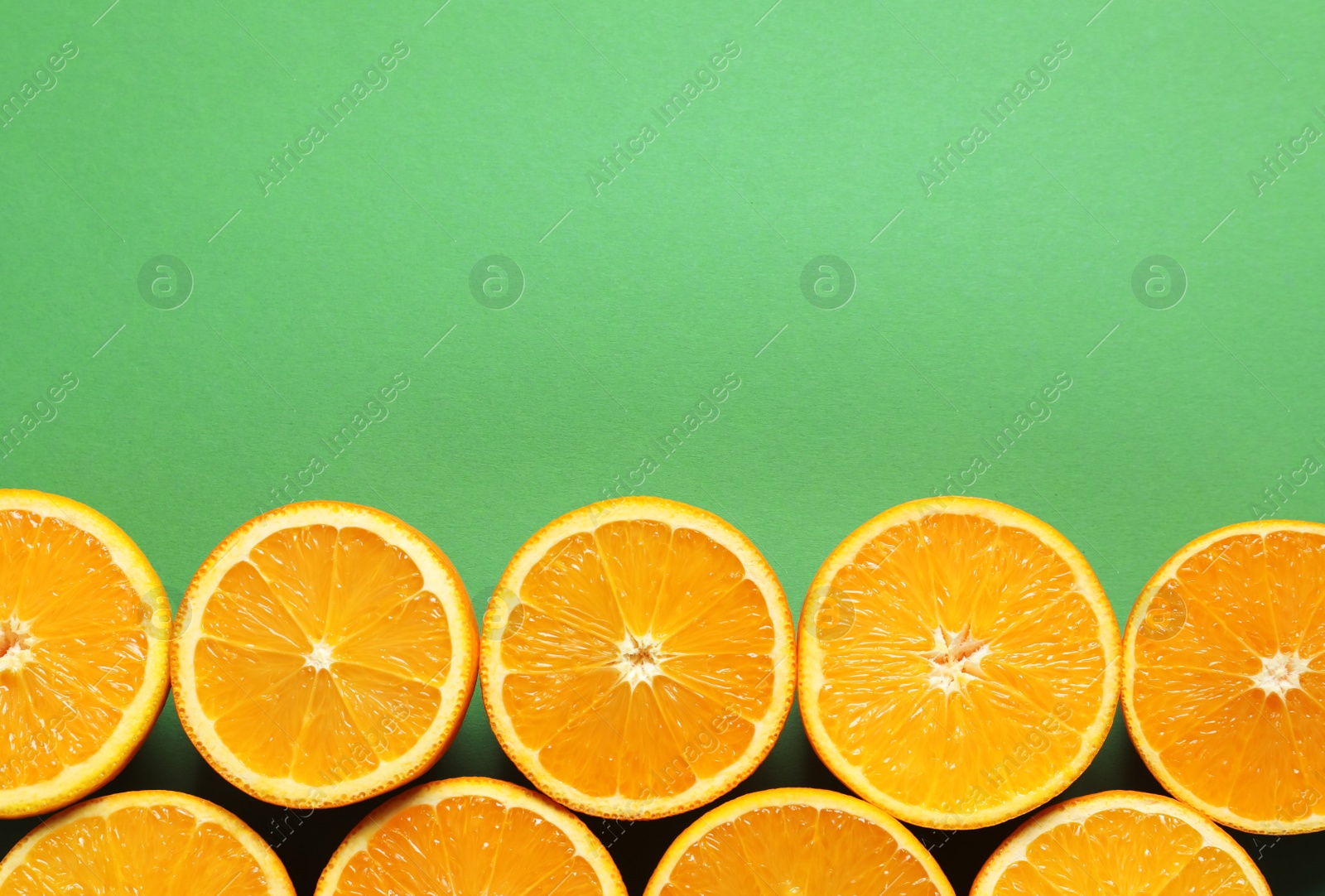 Photo of Flat lay composition with ripe oranges and space for text on color background