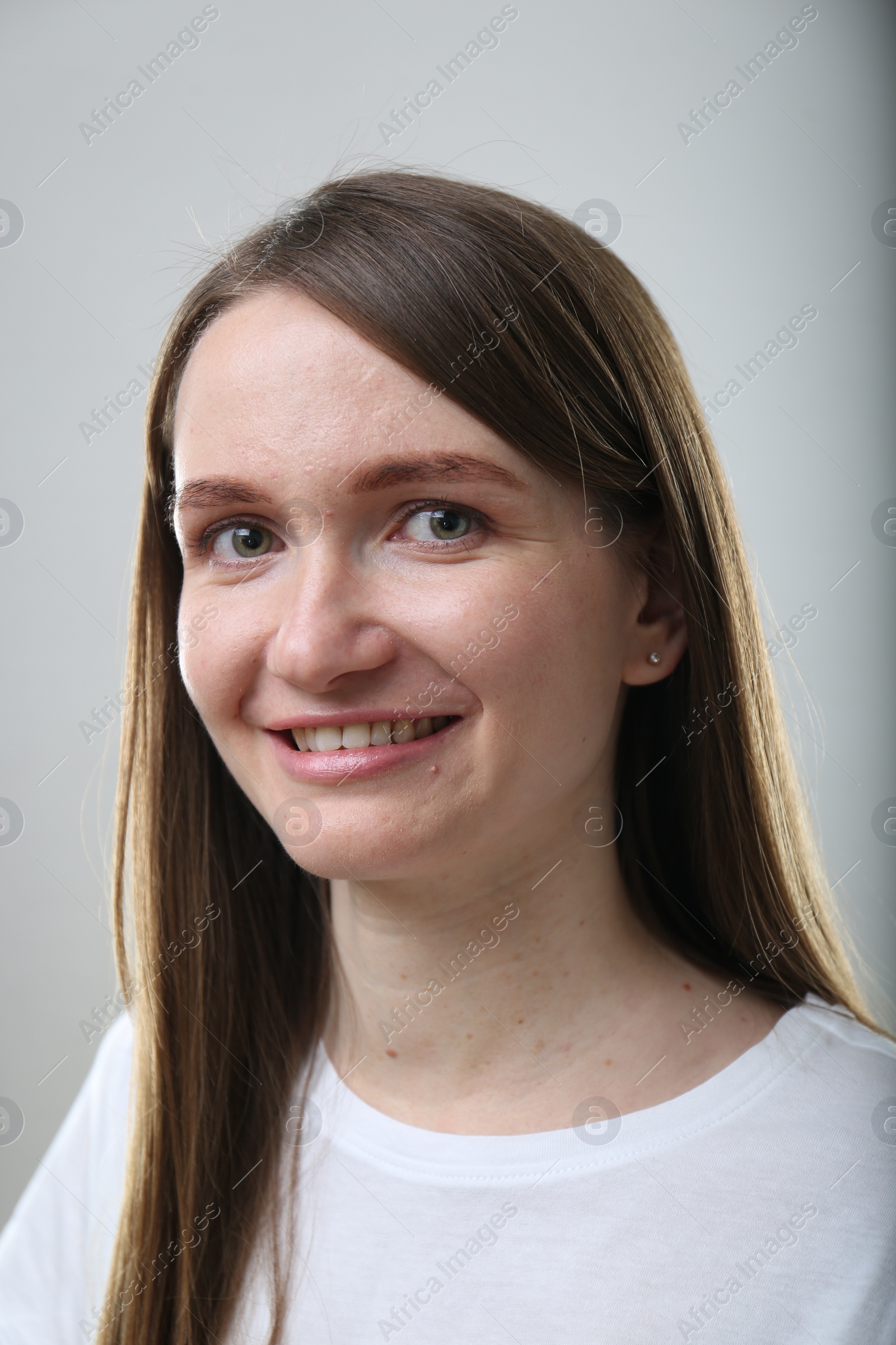 Photo of Portrait of beautiful happy woman on light grey background